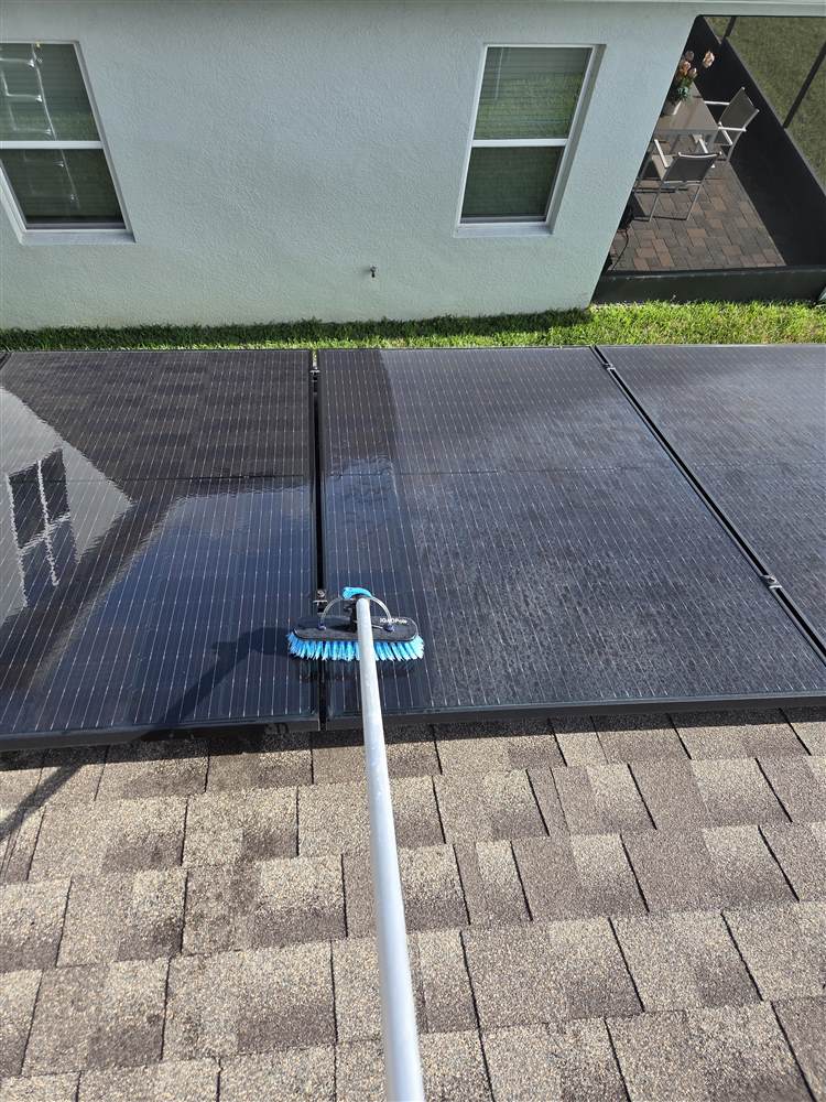 Micah from Pressure Wash Boss cleaning rooftop solar panels